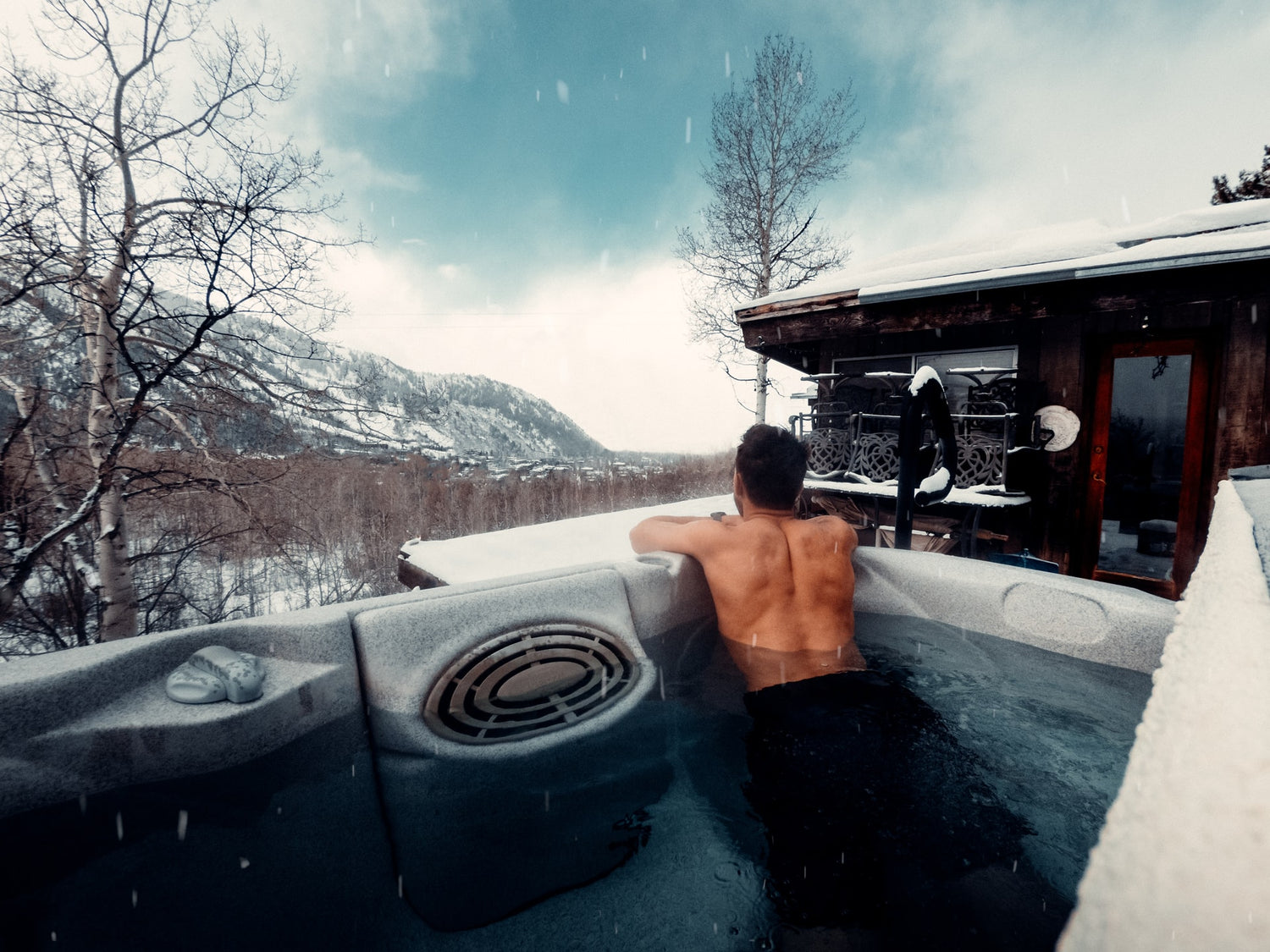Man looking into Mountains from Hot Tub